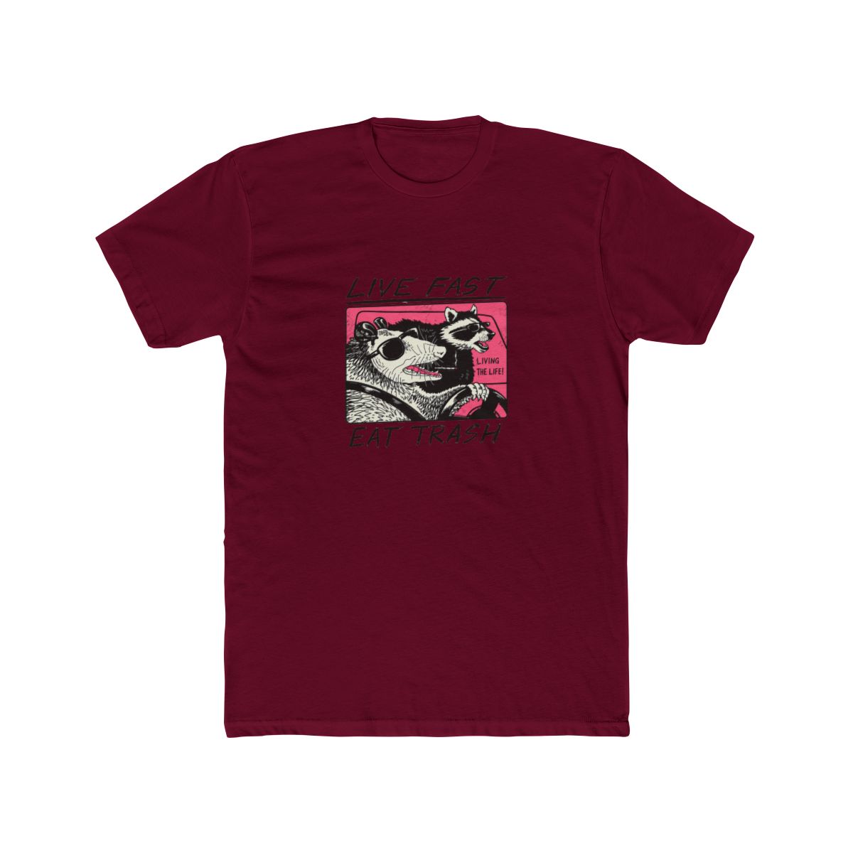 White T Shirt featuring a graphic of two animals driving a car. The text "Live Fast Eat Trash" is printed on the shirt. The animals are a raccoon and a possum. The raccoon is wearing sunglasses and...